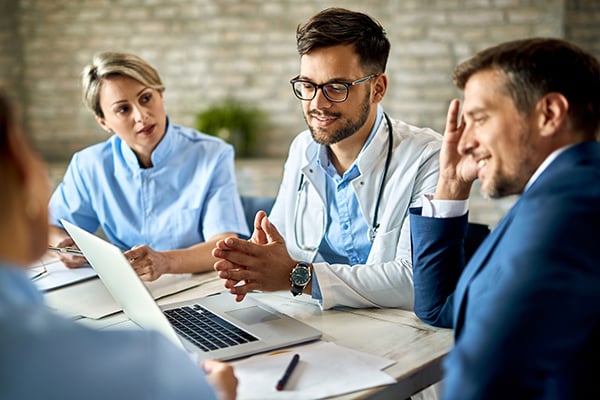 Clinical and medical consultants discussing around a table