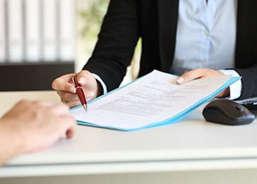 Person showing where to sign a document