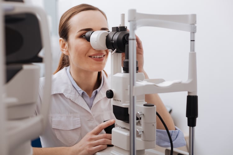 Woman looking into a microscope