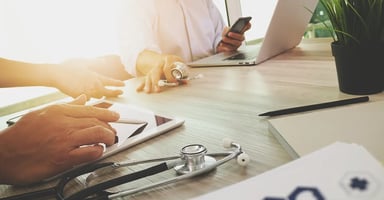 Medical professionals working together at a desk