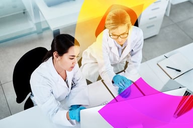 Two women collaborating together in a laboratory.