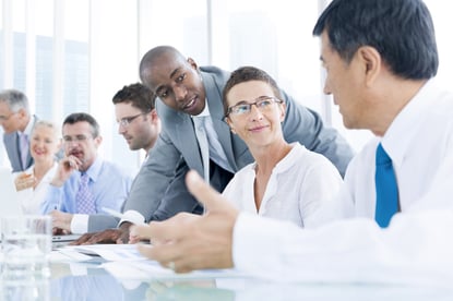 Professionals conversing at a conference table