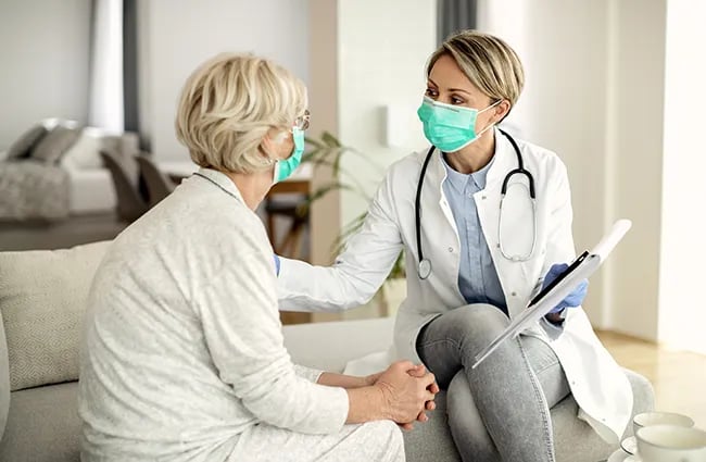 health-care-worker-with-a-patient-in-a-home-ss-1813098529-650x425