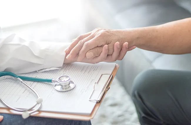 Patient holding healthcare providers hand