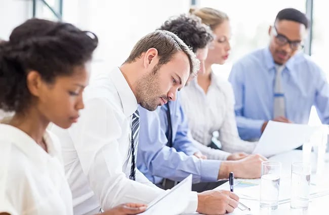 Row of business professionals working at conference table