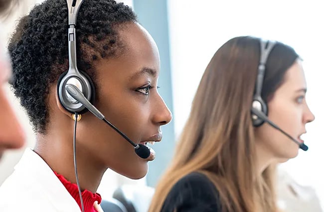Row of customer service professionals wearing headsets