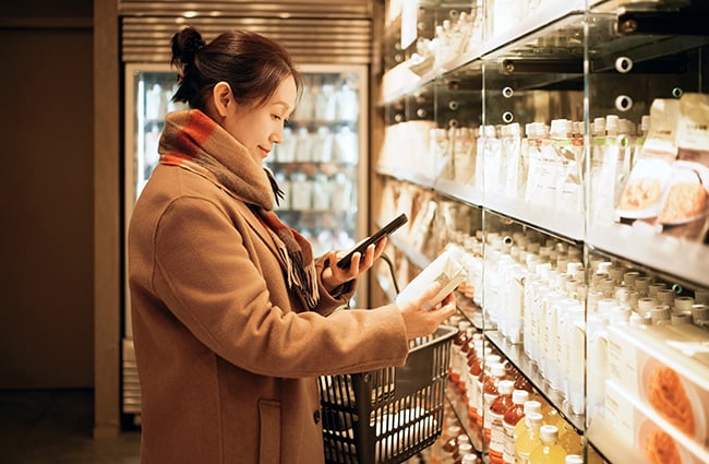 Woman shopping at store with smartphone