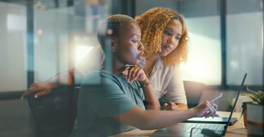 Coworkers collaborating on laptop