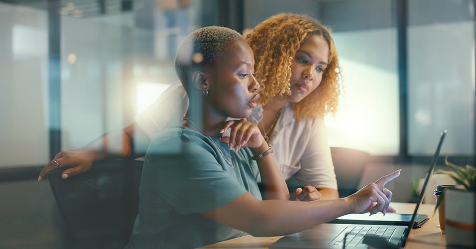 Coworkers collaborating on laptop