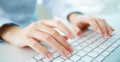 Hands typing on a keyboard