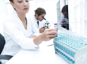 Woman working with test tubes in a laboratory environment