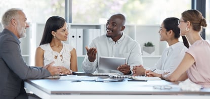 Group of people collaborating around a conference table