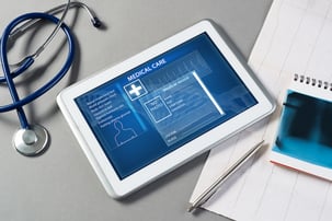 Tablet and stethoscope on a table