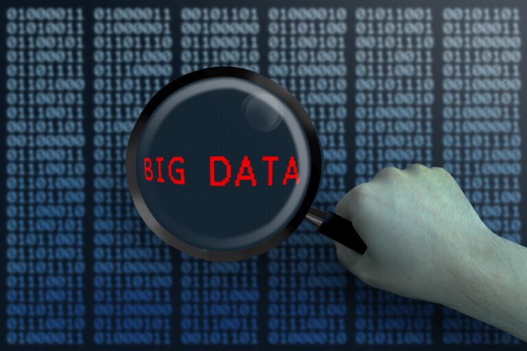 The words 'big data' enlarged by a magnifying glass with random binary digits in the background.
