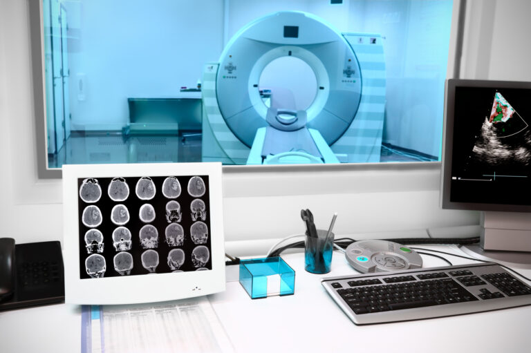 A monitoring laboratory with an MRI machine behind the glass.