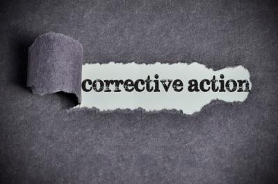 The words 'corrective action' revealed with a torn piece of paper.