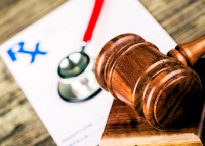 Gavel lying next to a presription paper in the background