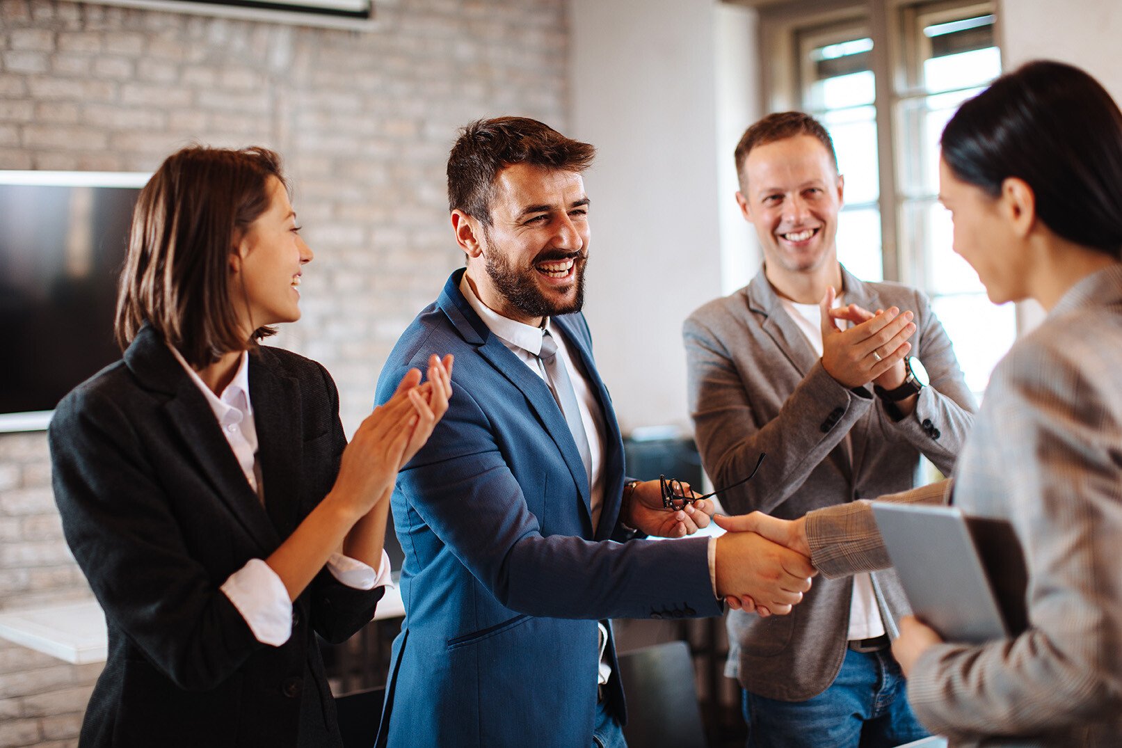 happy-executives-shaking-hands-as-307658586