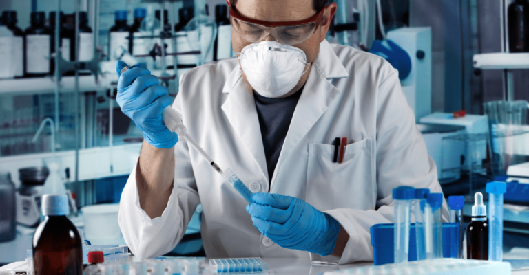 Lab technician injecting a substance into a vial in a labratory.