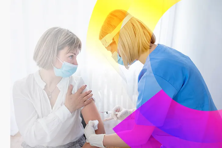 Decentralized clinical trial nurse injects a patient with a syringe.