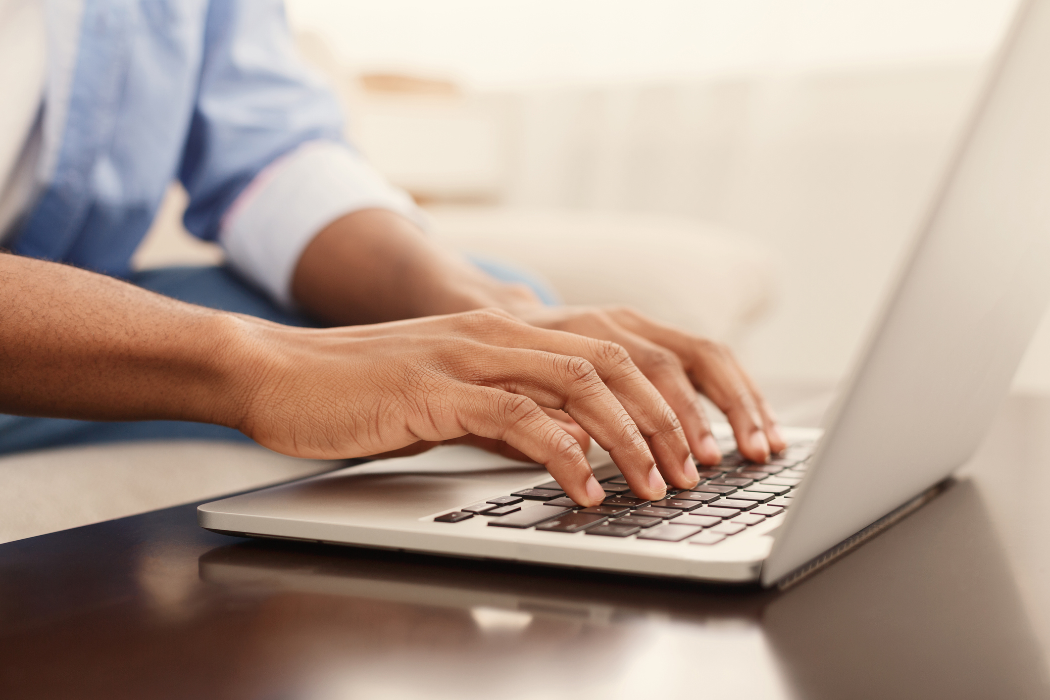 Hands working on a laptop