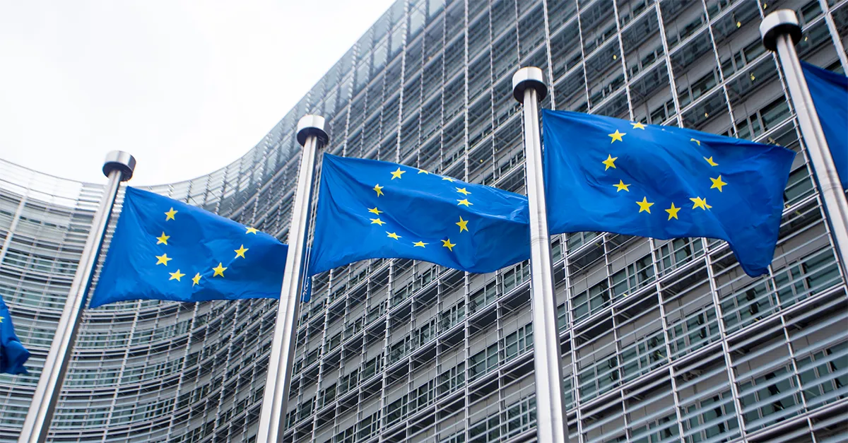 Group of EU flags flying in front of the Europa building